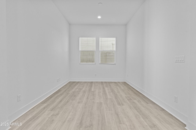 unfurnished room with recessed lighting, baseboards, and light wood-style flooring