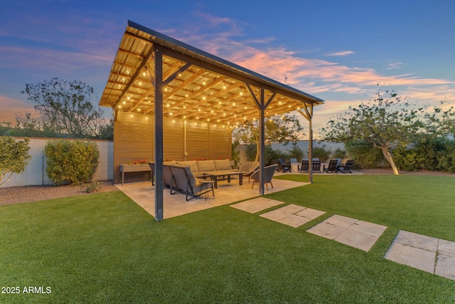 exterior space featuring a patio area, an outdoor living space, and a lawn