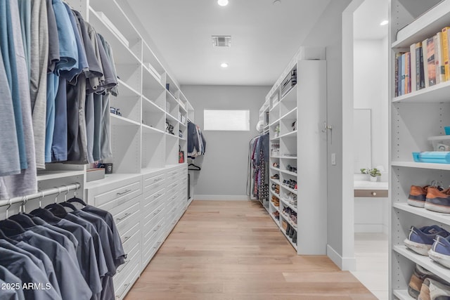 spacious closet featuring visible vents and light wood-type flooring