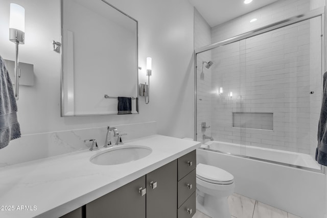 full bath with toilet, vanity, marble finish floor, and shower / bath combination with glass door