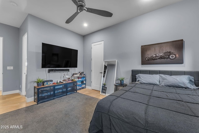 bedroom featuring a ceiling fan, wood finished floors, and baseboards