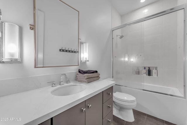 bathroom with tile patterned flooring, combined bath / shower with glass door, toilet, and vanity