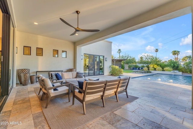 view of patio / terrace with an outdoor living space, an outdoor pool, and a ceiling fan