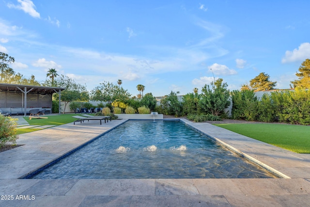 pool featuring a patio area and a yard