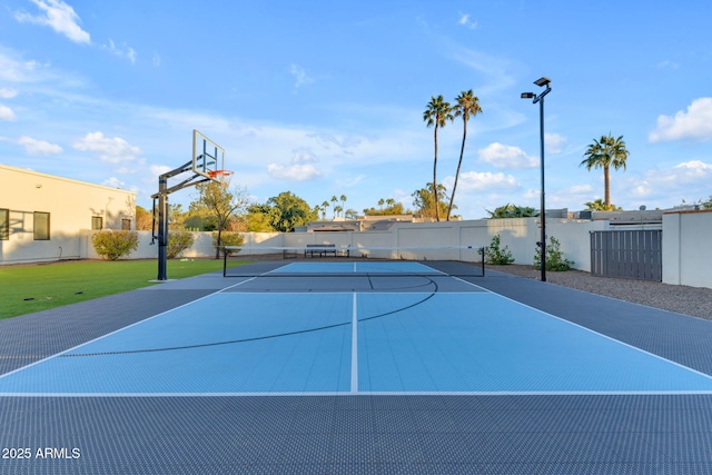 view of basketball court featuring community basketball court, fence, and a tennis court