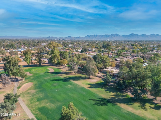 drone / aerial view with golf course view and a mountain view