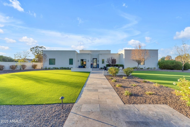 view of front of house with a front lawn and stucco siding