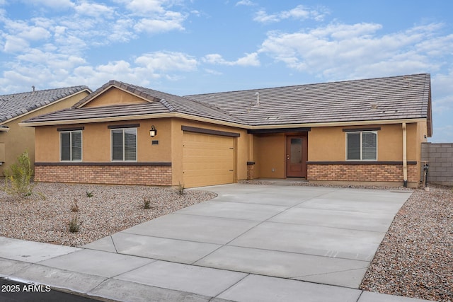 ranch-style home featuring an attached garage, stucco siding, driveway, and brick siding