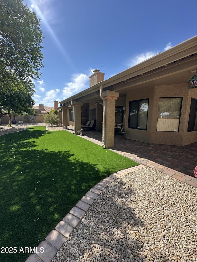view of yard featuring fence and a patio area