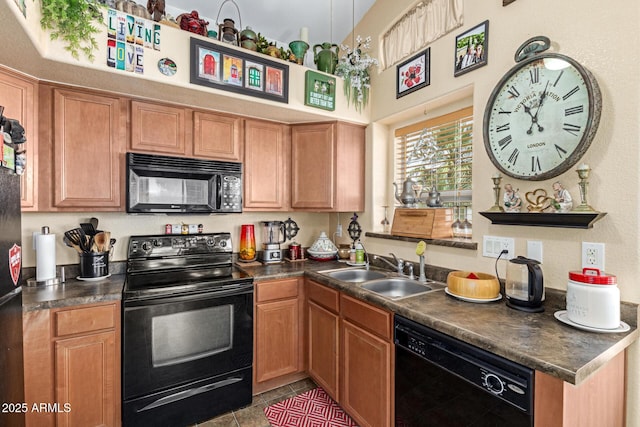 kitchen featuring dark countertops, a high ceiling, tile patterned floors, a sink, and black appliances