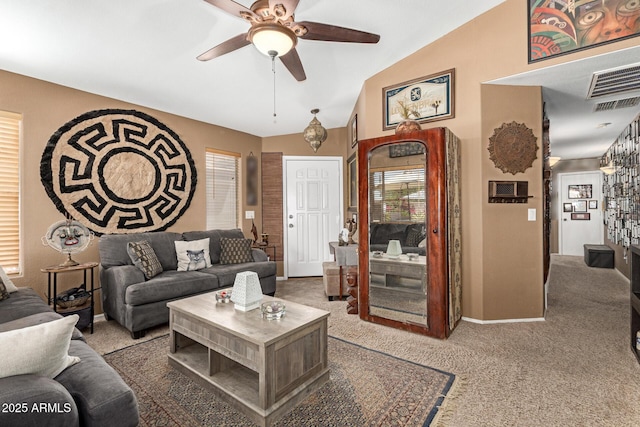 living room featuring plenty of natural light, carpet flooring, a ceiling fan, and visible vents