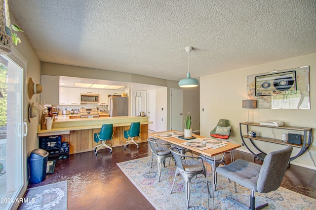 dining room featuring a textured ceiling