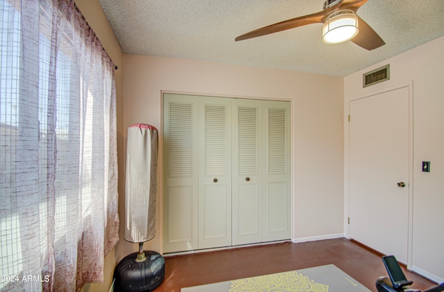 bedroom with a textured ceiling, a closet, and ceiling fan