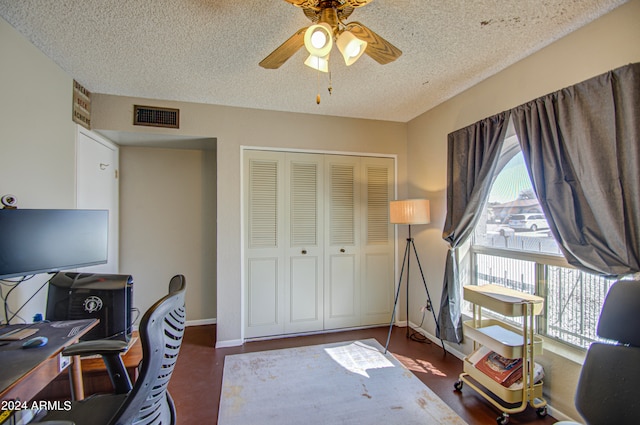 office with ceiling fan and a textured ceiling