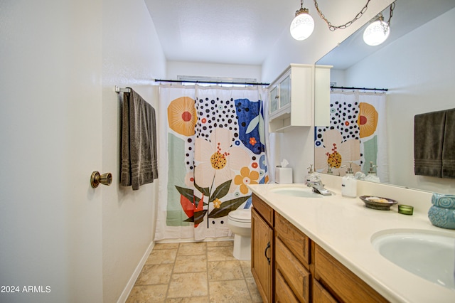 bathroom with vanity, toilet, and walk in shower