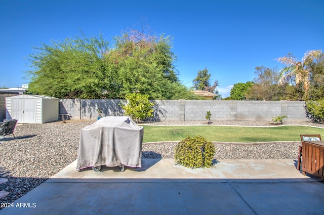 view of patio with a shed and grilling area