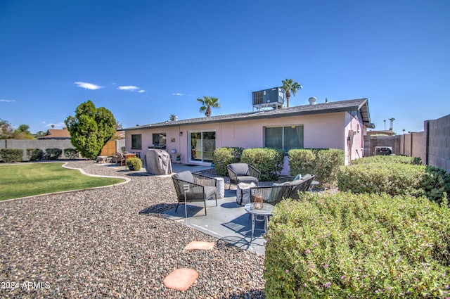 rear view of property featuring a patio and central AC unit