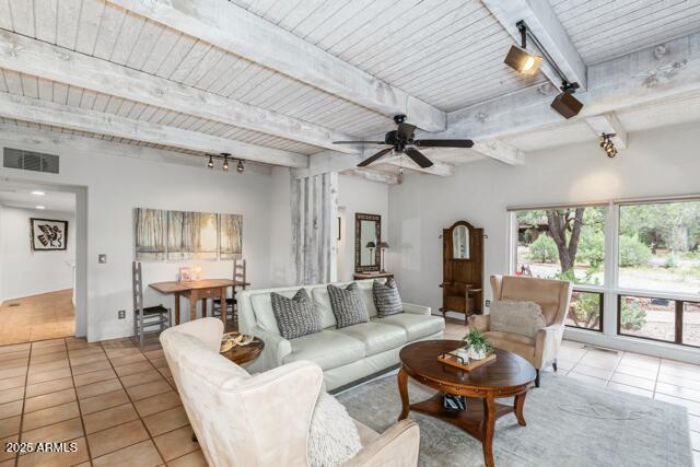 25 Edgewood Cir, Sedona, AZ 86336 - living room with light tile patterned flooring, ceiling fan, and wood ceiling with exposed beams