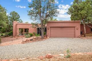 25 Edgewood Cir, Sedona, AZ 86336 - southwest-style home featuring driveway, an attached garage, and stucco siding