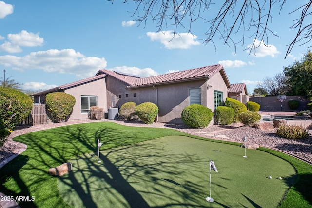 2207 W Hidden Treasure Way, Phoenix, AZ 85086 - view of side of home with stucco siding, a tile roof, and an area to practice putting