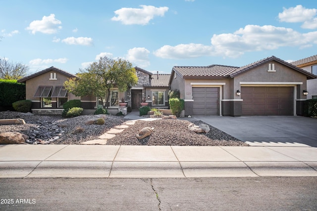 2207 W Hidden Treasure Way, Phoenix, AZ 85086 - view of front of property with an attached garage, stucco siding, a tile roof, and concrete driveway