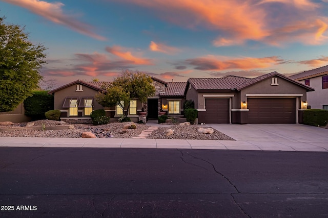 2207 W Hidden Treasure Way, Phoenix, AZ 85086 - view of front of property featuring a garage, a tiled roof, concrete driveway, and stucco siding