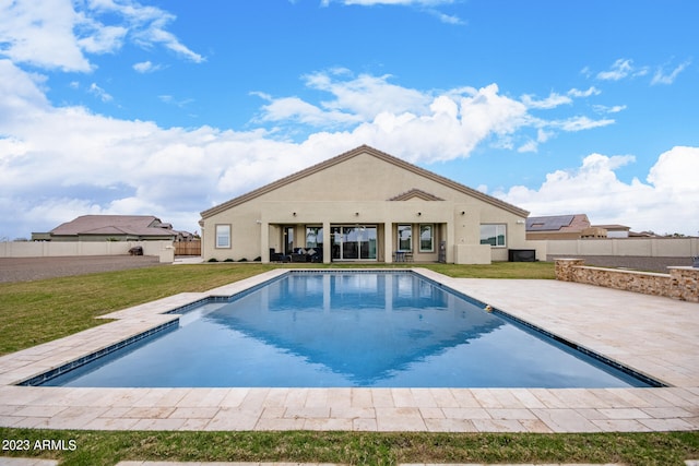 view of pool featuring a lawn and a patio