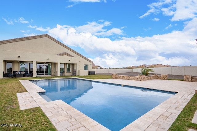 view of pool featuring a yard and a patio