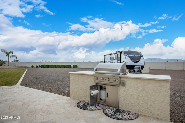 view of patio with grilling area and an outdoor kitchen