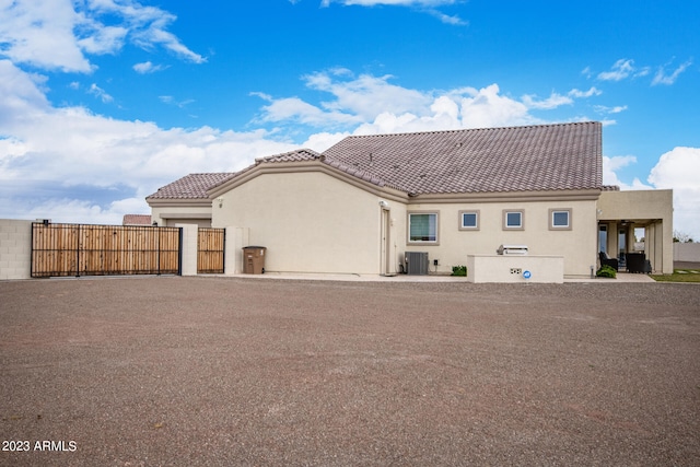 rear view of house featuring central air condition unit