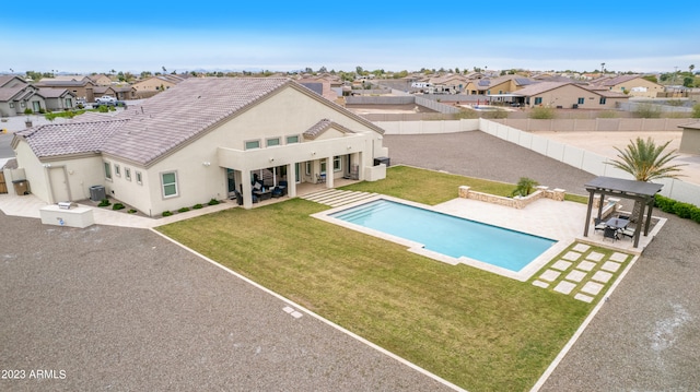 view of pool featuring central AC unit, a yard, and a patio area