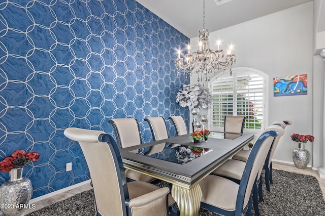 dining space featuring a chandelier and vaulted ceiling