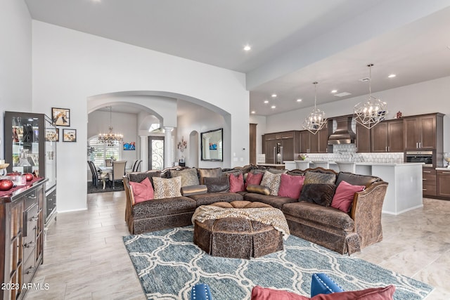 living room featuring light tile floors and a chandelier