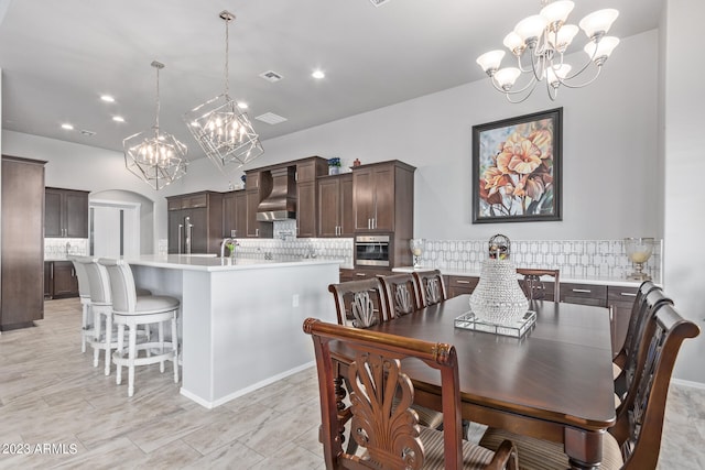 tiled dining area featuring a notable chandelier