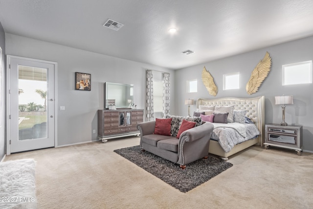 carpeted bedroom featuring access to exterior and multiple windows