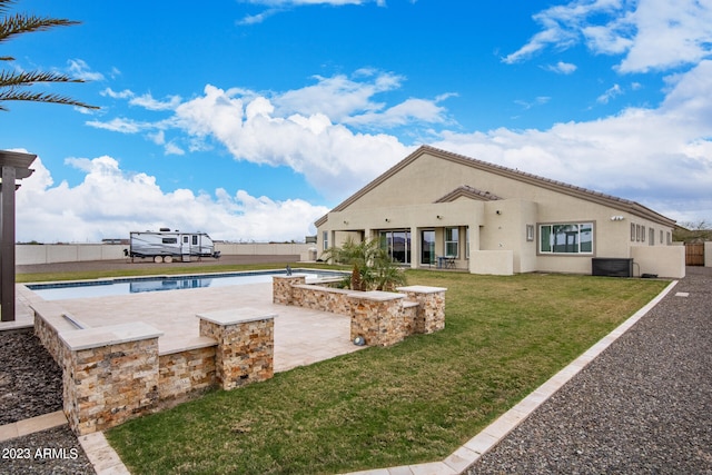 view of swimming pool with a yard and a patio area