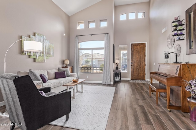 living room with dark wood-type flooring and a towering ceiling