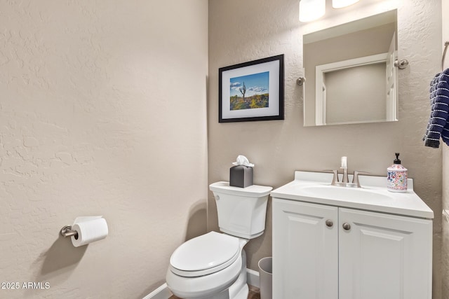 bathroom featuring toilet and vanity