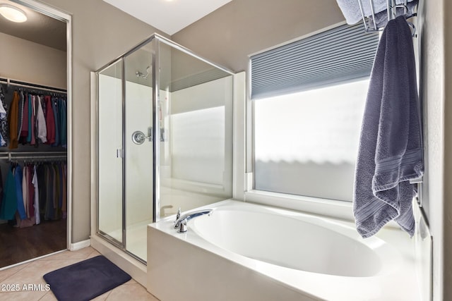 bathroom featuring separate shower and tub and tile patterned flooring