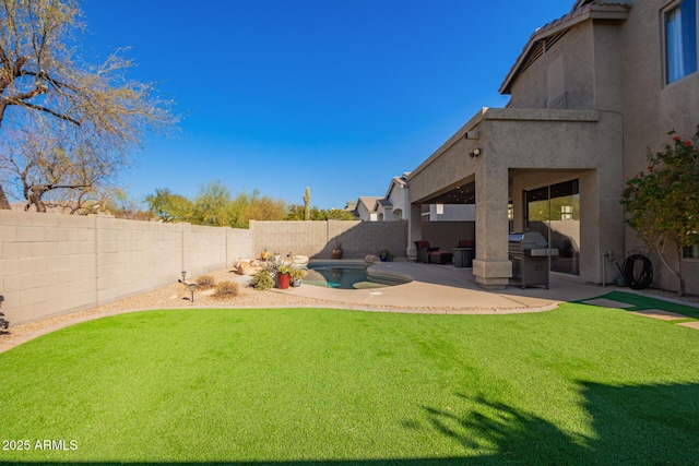 view of yard featuring a patio area and a fenced in pool