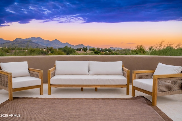 patio terrace at dusk with a mountain view and an outdoor hangout area