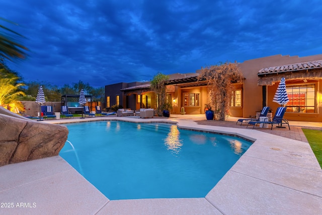 pool at dusk with a patio