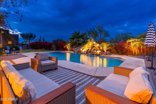 view of swimming pool with an outdoor living space, a patio, and a water slide