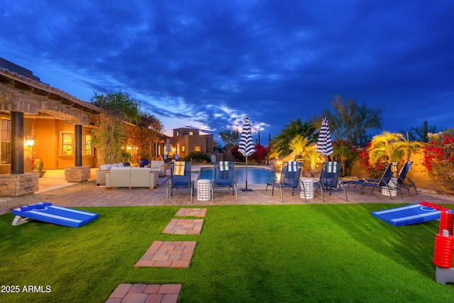 yard at dusk with a pool, a patio area, and outdoor lounge area