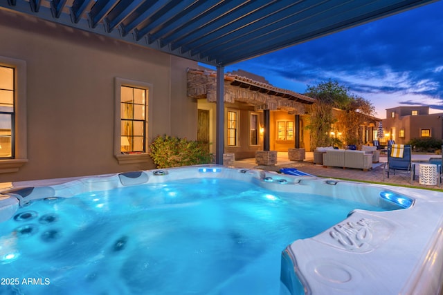 pool at dusk featuring an outdoor hangout area