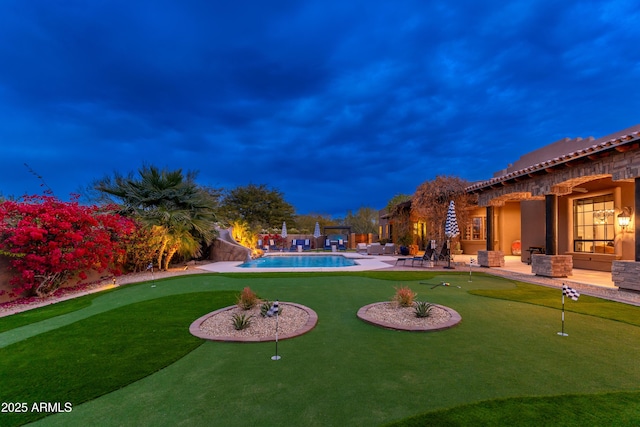 yard at dusk featuring a patio