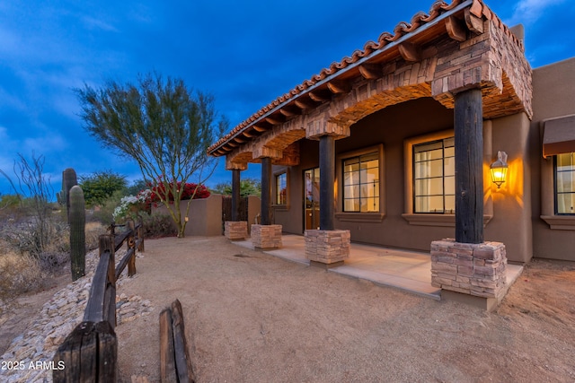 view of patio terrace at dusk