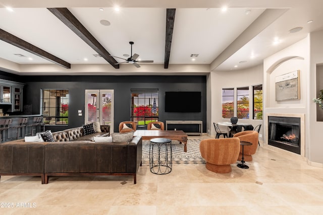 living room with beamed ceiling and ceiling fan