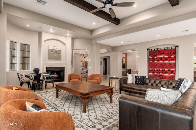 living room with ceiling fan and beam ceiling