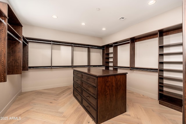 spacious closet with light parquet flooring